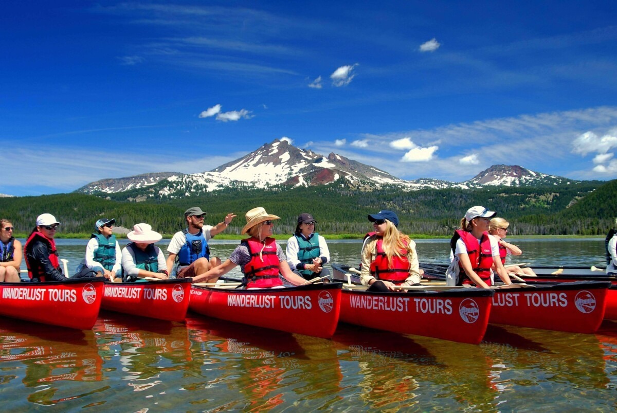 A group canoeing on their Oregon spring vacation to Bend.