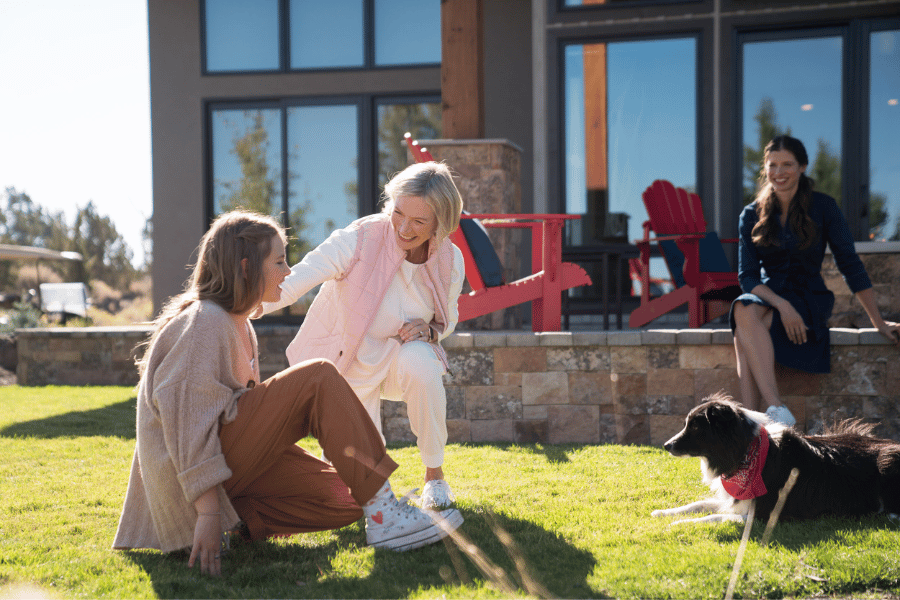 Guests relaxing with their dog outside a pet-friendly vacation rental at Juniper Preserve.